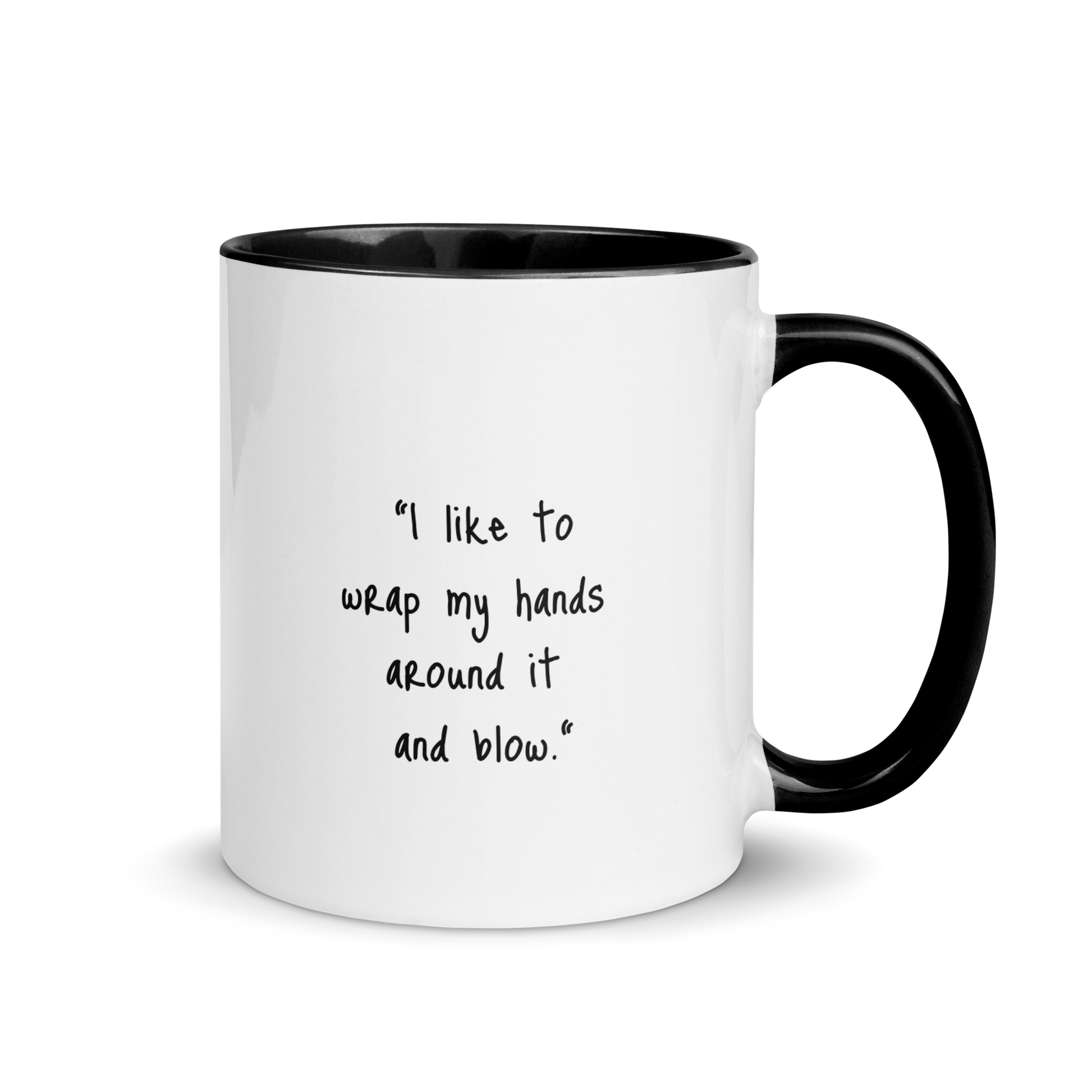 ceramic mug with colored rim and handle. The text "I like to wrap my hands around it and blow" is written on one side.