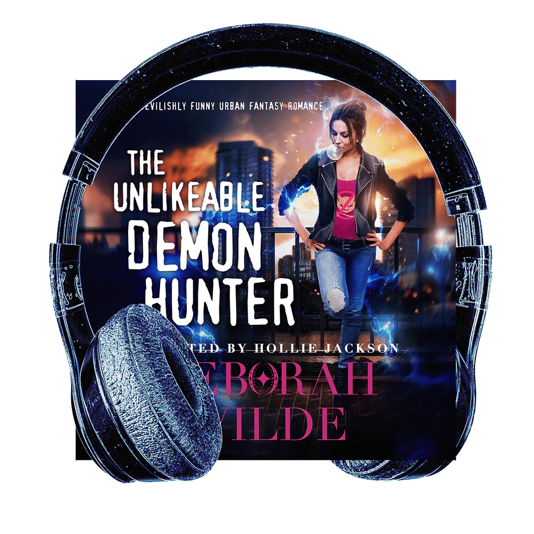 Headphones surround the audiobook cover of "The Unlikeable Demon Hunter" by Deborah Wilde, narrated by Hollie Jackson. A woman blowing bubblegum stands with hands on hips, wearing a red t-shirt with a "no demons" logo.