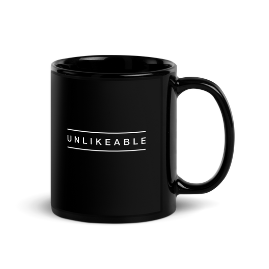 black glossy mug with the word unlikeable in white.